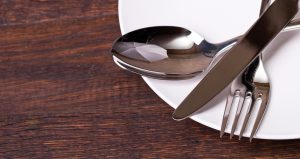 Table settings on wooden background.